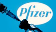 FILE PHOTO: A vial and syringe are seen in front of a displayed Pfizer logo in this illustration taken January 11, 2021. REUTERS/Dado Ruvic/Illustration/File Photo
