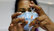 A medical worker prepares a syringe at a coronavirus disease (COVID-19) vaccination center in Singapore, March 8, 2021. REUTERS/Edgar Su/File Photo