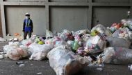 A staff member wearing a protective mask waits for trash trucks to arrive to the waste collection plant, following the coronavirus disease (COVID-19) outbreak in Taipei, Taiwan July 15, 2021. REUTERS/Ann Wang