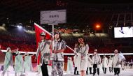 Tokyo 2020 Olympics - The Tokyo 2020 Olympics Opening Ceremony - Olympic Stadium, Tokyo, Japan - July 23, 2021. Flag bearers Kanykei Kubanychbekova of Kyrgyzstan and Denis Petrashov of Kyrgyzstan lead their contingent during the athletes' parade at the op