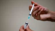 A medical worker prepares a dose of the Pfizer-BioNTech vaccine against the coronavirus disease (COVID-19) in a vaccination center. REUTERS/Sarah Meyssonnier
