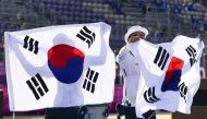 July 24, 2021. An San of South Korea and Kim Je Deok of South Korea wave their national flags after winning gold REUTERS/Clodagh Kilcoyne