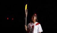 July 23, 2021 Naomi Osaka of Japan carries the Olympic torch at the opening ceremony REUTERS/Hannah Mckay