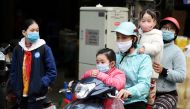  A family wears protective masks as they ride a motorbike in the street amid the coronavirus disease (COVID-19) outbreak in Hanoi, Vietnam, January 29, 2021. REUTERS/Thanh Hue/File Photo
