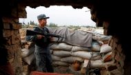An Afghan policeman keeps watch at the check post on the outskirts of Kabul, Afghanistan July 13, 2021. (Reuters/Mohammad Ismail//File Photo)