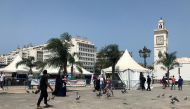 FILE PHOTO: People walk past tents erected during a coronavirus disease (COVID-19) vaccination campaign that is taking place outside mosques, after Friday Prayers in Algiers, Algeria July 9, 2021. REUTERS/Abdelaziz Boumzar
