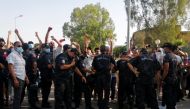 Police officers stand guard as supporters of Tunisia's biggest political party gather outside the parliament building in Tunis, Tunisia July 26, 2021. Reuters/Jihed Abidellaoui