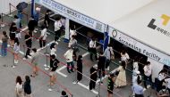 People wait in line for a coronavirus disease (COVID-19) test at a testing site which is temporarily set up at a public health center in Seoul, South Korea, July 9, 2021. REUTERS/ Heo Ran/File Photo/File Photo