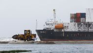 A wheel loader clears the ground near stranded cargo ship MV Heng Tong 77 at Sea View beach in Karachi, Pakistan July 26, 2021. REUTERS/Akhtar Soomro
