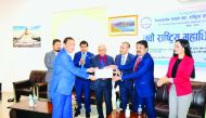 Ambassador of Nepal to Qatar, H E Dr. Narad Nath Bharadwaj, with newly elected members of NRNA’s National Coordination Council Qatar, during an event.