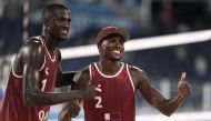 Cherif Younousse of Qatar and Ahmed Tijan of Qatar pose for a picture as they celebrate winning their match against Italy. REUTERS/Pilar Olivares