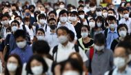 Commuters wearing protective masks amid the coronavirus disease (COVID-19) outbreak make their way at Shinagawa station in Tokyo, Japan, July 28, 2021. REUTERS/Kim Kyung-Hoon
