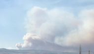 A plume of smoke billows over Qobayat, as seen from Kaa, Lebanon July 28, 2021 in this still image taken from social media video.Tony Tom /via REUTERS