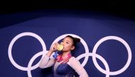 Tokyo 2020 Olympics - Gymnastics - Artistic - Women's Individual All-Around - Medal Ceremony - Ariake Gymnastics Centre, Tokyo, Japan - July 29, 2021. Gold medallist Sunisa Lee of the United States kisses her medal in front of the olympic rings REUTERS/Li