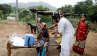 FILE PHOTO: Healthcare worker Jankhana Prajapati gives a dose of the domestically manufactured COVISHIELD vaccine to villager Amiyaben Dabhi during a door-to-door vaccination drive in Banaskantha district in the western state of Gujarat, India, July 23, 2