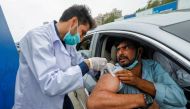 A resident receives a vaccine against coronavirus disease (COVID-19) at a drive-through vaccination facility in Karachi, Pakistan July 29, 2021. REUTERS/Akhtar Soomro/File Photo