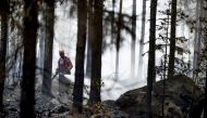 Fire departments and volunteers work to control a forest fire in Pyharanta, Western Finland July 19, 2018. Roni Lehti/Lehtikuva via Reuters