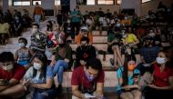 Filipinos use their smartphones while queueing for free vaccination against the coronavirus disease (COVID-19) at San Andres Sports Complex in Manila, Philippines, July 21, 2021. REUTERS/Eloisa Lopez/File Photo/File Photo