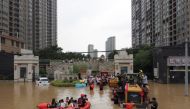 Rescue workers evacuate residents from a flooded residential compound following heavy rainfall in Zhengzhou, Henan province, China July 22, 2021. Picture taken with a drone. REUTERS/Aly Song