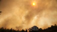 Firefighters extinguish a wildfire in the Mazi region near Bodrum, Turkey, August 2, 2021. REUTERS/Kenan Gurbuz