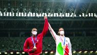 Gold medallists, Mutaz Barshim of Qatar and Gianmarco Tamberi of Italy celebrate on the podium during the medal ceremony of the men’s high jump, yesterday.