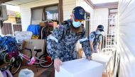 Australian Defence Force personnel and NSW police deliver emergency food parcels for people in lockdown in the Fairfield suburb in the southwest of Sydney, Australia, August 2, 2021. AAP Image/Mick Tsikas via Reuters 