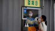 A woman gets a coronavirus disease (COVID-19) test at a coronavirus testing site in Seoul, South Korea, July 15, 2021. REUTERS/Kim Hong-Ji/File Photo