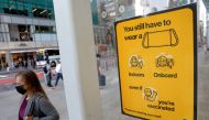 A poster alerting for the wearing of masks is seen on a 42nd Street subway entrance as cases of the infectious coronavirus Delta variant continue to rise in New York City, on August 2, 2021. (REUTERS/Andrew Kelly)