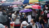 People walk through a crowded market on a rainy day amidst the spread of the coronavirus disease (COVID-19) in Mumbai, India, July 14, 2021. REUTERS/Francis Mascarenhas/File Photo

