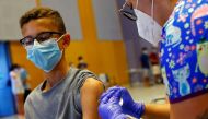 A nurse administers the first dose of the Moderna vaccine against coronavirus disease (COVID-19) to 14-year-old Jorge Hernandez at a vaccination centre in Meloneras on the island of Gran Canaria, Spain, July 28, 2021. REUTERS/Borja Suarez/File Photo