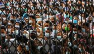 People wearing protective face masks stand in line wait to receiving a dose of the vaccine against the coronavirus disease (COVID-19), during a vaccination program at the provincial government building in Medan, North Sumatra province, Indonesia August 3,