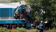 An emergency personnel works on a site of a train crash near the town of Domazlice, Czech Republic, August 4, 2021. REUTERS/David W Cerny