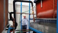 Spanish Aquaer company engineer and inventor, Enrique Veiga, 82, checks the first start-up of a machine which he invented to extract drinking water from thin air, in Carrion de los Cespedes, near Seville, Spain July 28, 2021. Picture taken July 28, 2021. 