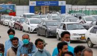 Residents line up to receive a vaccine against coronavirus disease (COVID-19) at a drive-through vaccination facility in Karachi, Pakistan July 29, 2021. REUTERS/Akhtar Soomro