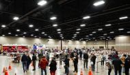 FILE PHOTO: People wait in line to be inoculated against the coronavirus disease (COVID-19) at a vaccination site at the Esports Stadium Arlington & Expo Center in Arlington, Texas, U.S. February 12, 2021.  REUTERS/Cooper Neill