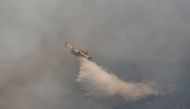 A firefighting plane from Spain drops water to a wildfire near Koycegiz, Turkey, August 4, 2021. REUTERS/Umit Bektas/File Photo