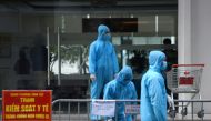 Medical workers in protective suits stand outside a quarantined building amid the coronavirus disease (COVID-19) outbreak in Hanoi, Vietnam, January 29, 2021. REUTERS/Thanh Hue/File Photo/File Photo/File Photo