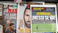 Newspapers are seen displaying front page images of Barcelona's Lionel Messi at a newspaper selling stall outside the Camp Nou. (REUTERS/File Photo)