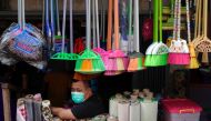 A household goods vendor wearing a protective mask waits for customers amid the coronavirus disease (COVID-19) pandemic in Jakarta, Indonesia, August 9, 2021. REUTERS/Willy Kurniawan