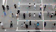 People wait in line for a coronavirus disease (COVID-19) test at a testing site which is temporarily set up at a public health center in Seoul, South Korea, July 9, 2021. REUTERS/ Heo Ran/File Photo