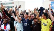 August 10, 2021 Paris St Germain fans celebrate as they await the arrival of Lionel Messi outside Paris-Le Bourget airport REUTERS/Yves Herman