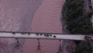 An aerial view shows a herd of wild Asian elephants crossing the Yuanjiang River in Yuanjiang county of Yuxi, Yunnan province, China August 8, 2021. The herd of 14 wild Asian elephants is on its way back to its traditional habitat, according to provincial