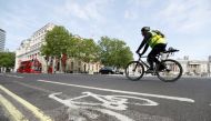 A man cycles by a cycle lane in Trafalgar Square, following the outbreak of the coronavirus disease (COVID-19), London, Britain, May 16, 2020. REUTERS/Peter Nicholls/File Photo