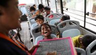 Gauri, 8, reacts inside a parked bus run by TejasAsia, an NGO using 