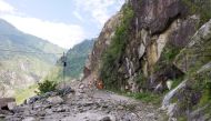 Members of the National Disaster Response Force (NDRF) search for survivors during a rescue operation at the site of a landslide in Kinnaur district in the northern state of Himachal Pradesh, India, August 11, 2021. National Disaster Response Force/Handou