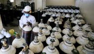 Walter Otieno, plant operator at Hewatele, an innovative oxygen supply company,, arranges empty oxygen medical cylinder tanks amid the coronavirus disease (COVID-19) pandemic, at the Hewatele oxygen plant in Nairobi, Kenya August 3, 2021. Picture taken Au