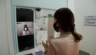 A hospital staff and Hallym University Medical Center (HUMC) director Lee Me-yeon (on screen) simulate a contactless medical check-up at a smart booth, amid the coronavirus disease (COVID-19) pandemic, in Anyang, South Korea August 12, 2021. REUTERS/Daewo
