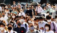 People wearing protective masks, amid the coronavirus disease (COVID-19) outbreak, make their way in Tokyo, Japan, August 6, 2021. REUTERS/Kim Kyung-Hoon
