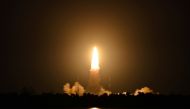 People watch as India's Geosynchronous Satellite Launch Vehicle (GSLV-F10), carrying the earth observation satellite EOS-03, lifts off from the Satish Dhawan Space Centre in Sriharikota, India, August 12, 2021. REUTERS/Stringer