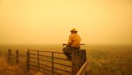 Juan Valencia, a crewman from Porterville, California keeps an eye out for spot fires from the Dixie Fire near Taylorsville, California, U.S., August 11, 2021. REUTERS/David Swanson